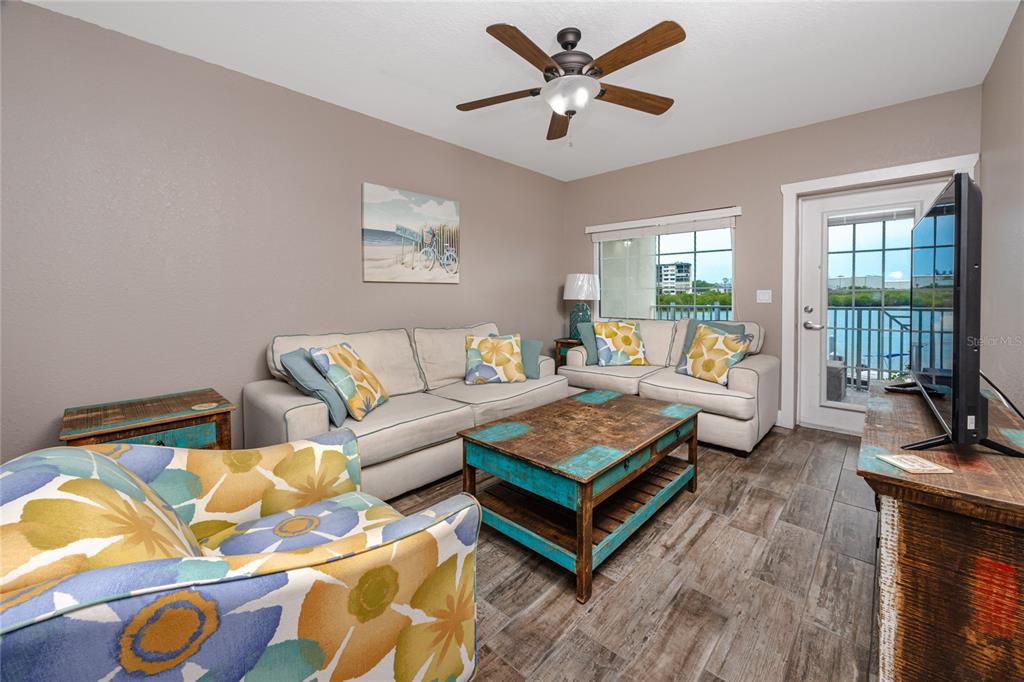 399 2nd Street, Unit 217 Indian Rocks Beach, FL 33785 - Photo 3 of 44 a living room with furniture and a large window