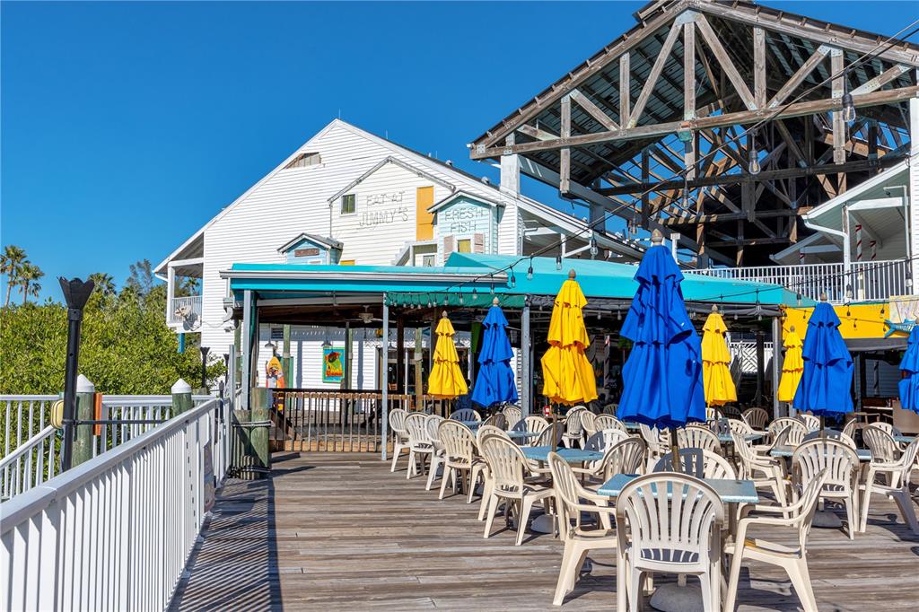 399 2nd Street, Unit 217 Indian Rocks Beach, FL 33785 - Photo 42 of 44 a view of a chairs and table in a patio