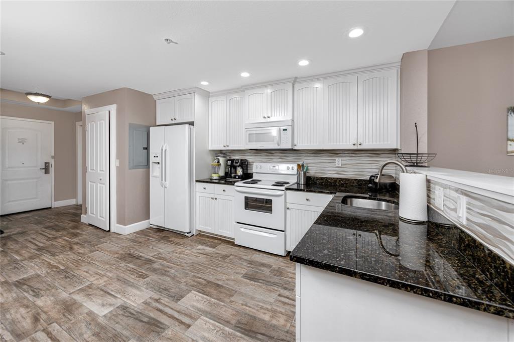 399 2nd Street, Unit 217 Indian Rocks Beach, FL 33785 - Photo 6 of 44 a kitchen with refrigerator and cabinets