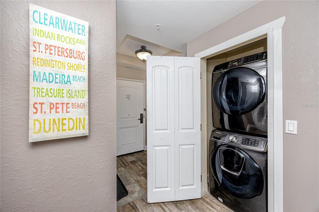 399 2nd Street, Unit 217 Indian Rocks Beach, FL 33785 - Photo 7 of 44 a view of a hallway with washer and dryer