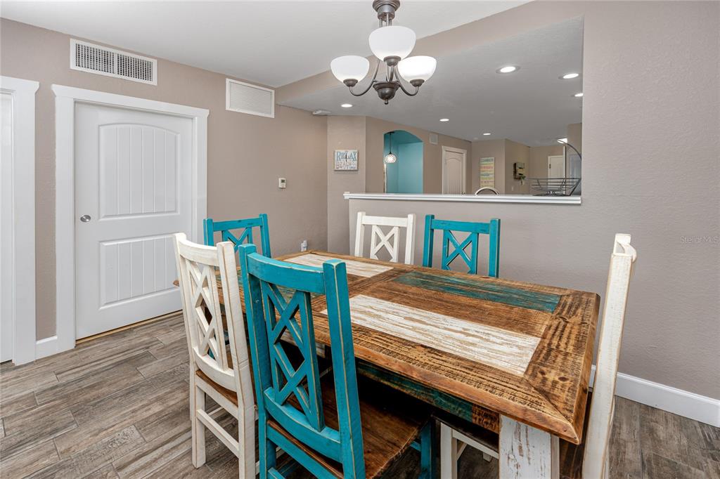 399 2nd Street, Unit 217 Indian Rocks Beach, FL 33785 - Photo 10 of 44 a view of a dining room with furniture and wooden floor
