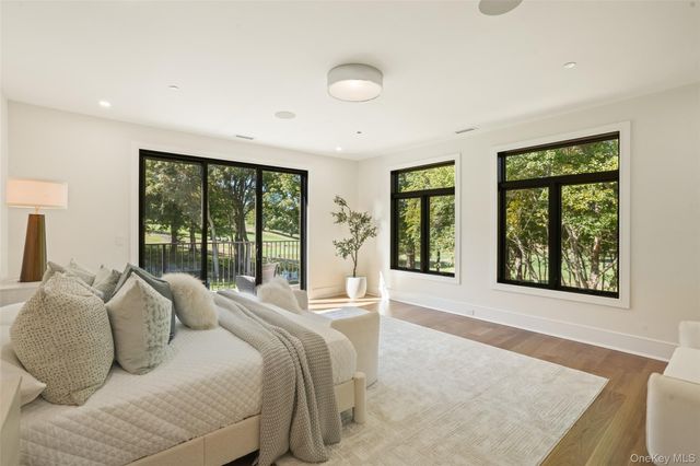 a spacious bedroom with a large bed and a large window