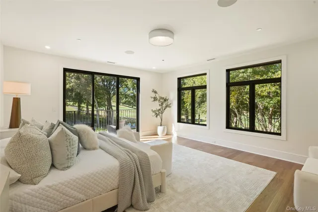 a spacious bedroom with a large bed and a large window