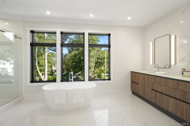 a spacious bathroom with a large tub and large window
