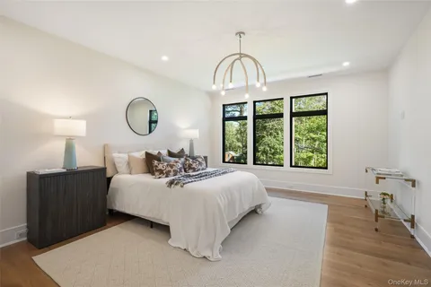 a bed room with a bed and a large window