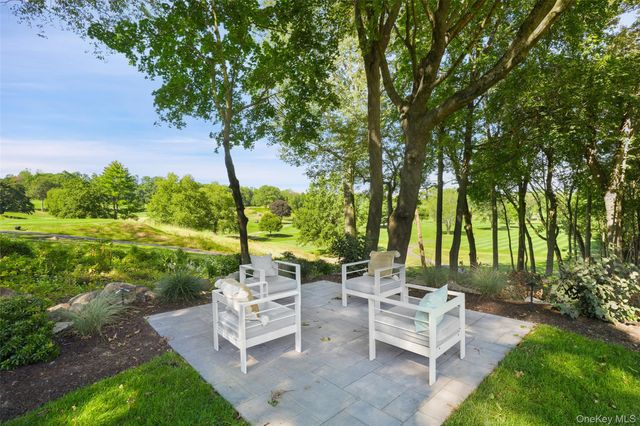 a view of a patio with a table chairs and a garden