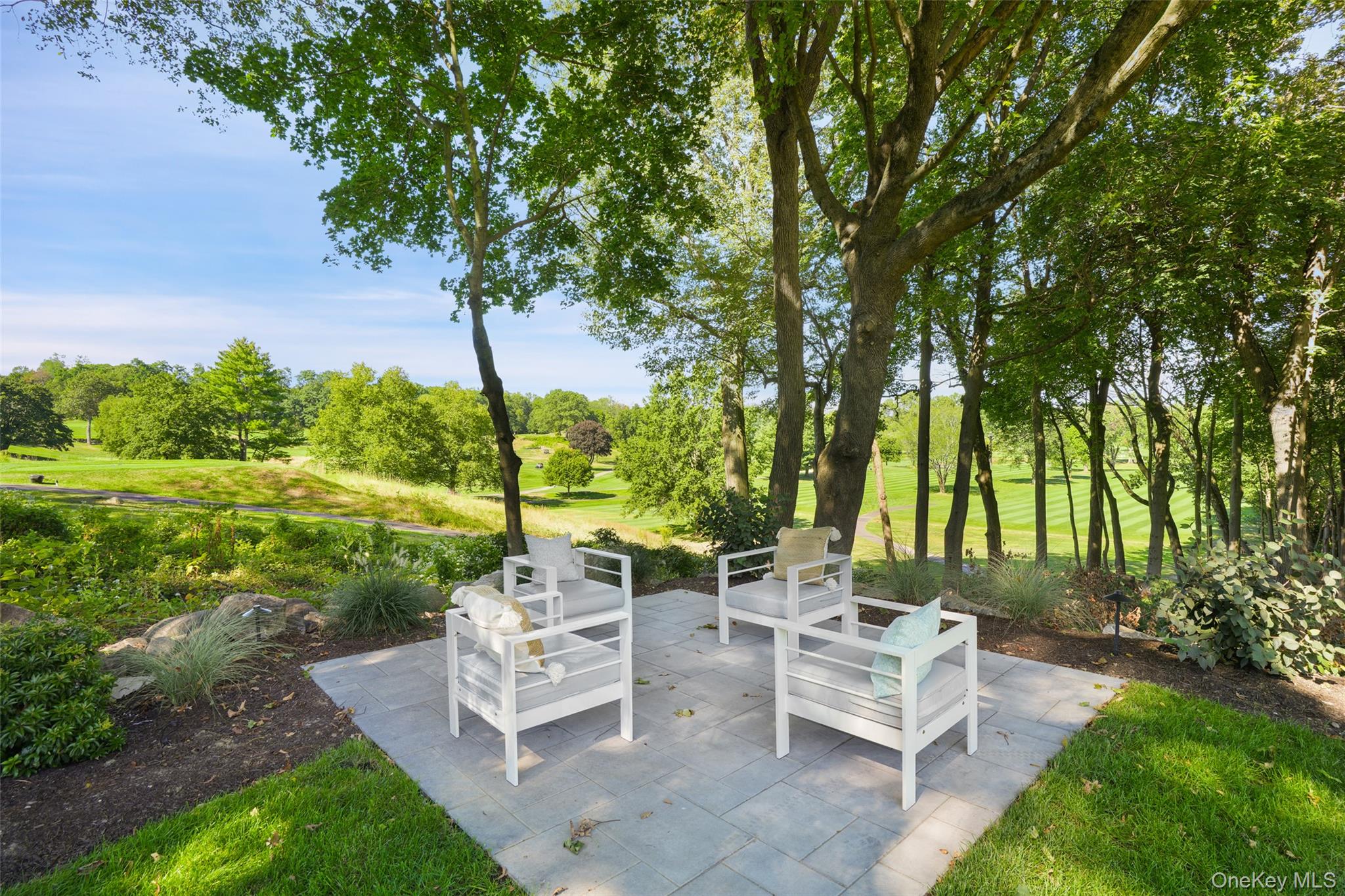 11 Boxwood Lane Rye, NY 10580 - Photo 24 of 29 a view of a patio with a table chairs and a garden