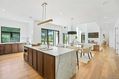 a kitchen with stainless steel appliances granite countertop a stove and a wooden floors