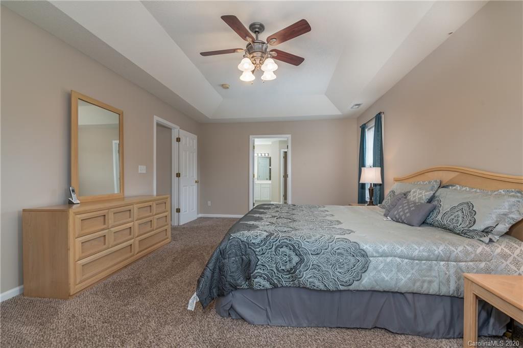 52 Wildbriar Road Fletcher, NC 28732 - Photo 23 of 29 a bedroom with a bed and ceiling fan
