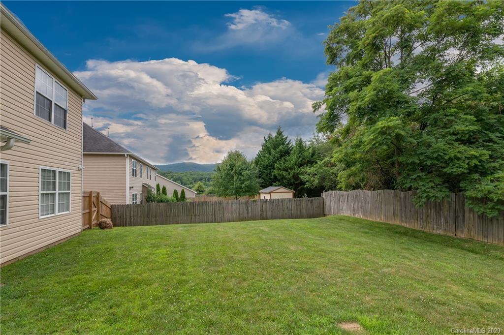 52 Wildbriar Road Fletcher, NC 28732 - Photo 28 of 29 a view of a backyard with a small cabin