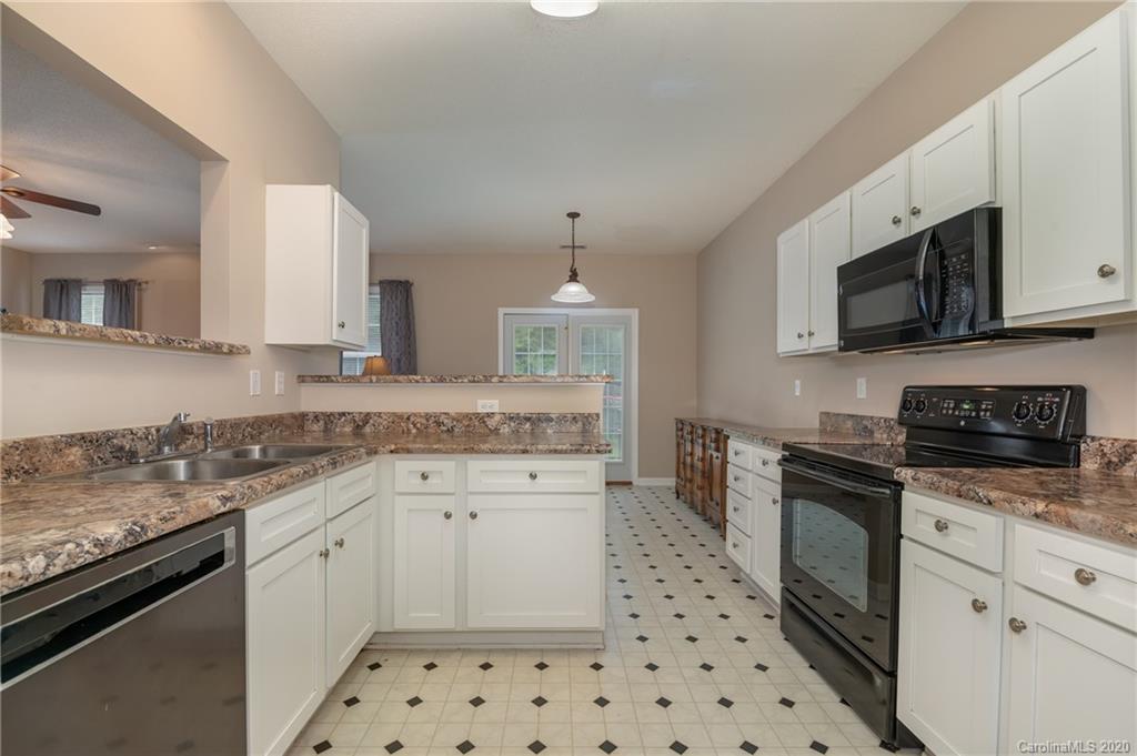 52 Wildbriar Road Fletcher, NC 28732 - Photo 7 of 29 a kitchen with granite countertop a sink stainless steel appliances and white cabinets