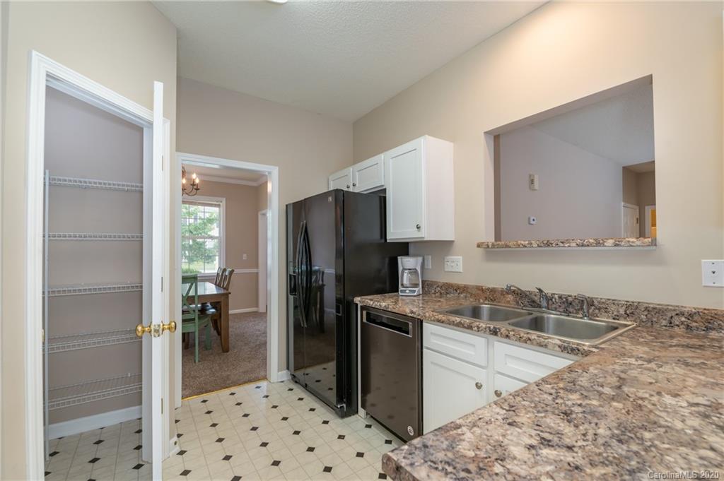 52 Wildbriar Road Fletcher, NC 28732 - Photo 8 of 29 a kitchen with granite countertop a refrigerator and a stove top oven