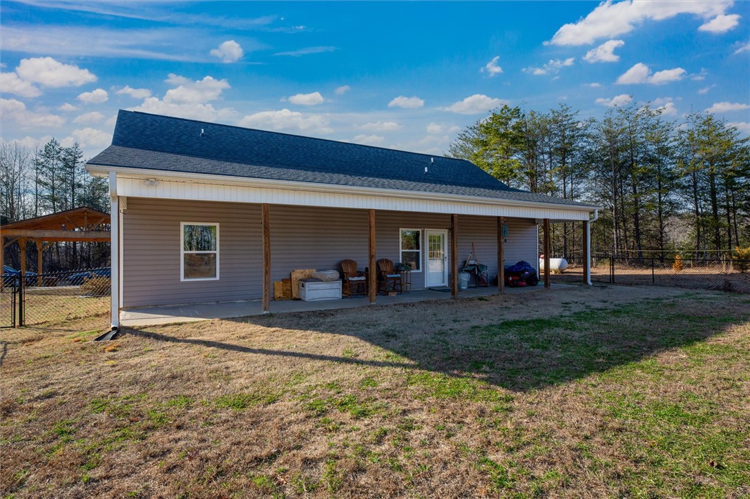 67 Sawblade Ridge Marietta, SC 29661 - Photo 36 of 37 A spacious covered back porch runs along the rear of this vinyl-sided home.