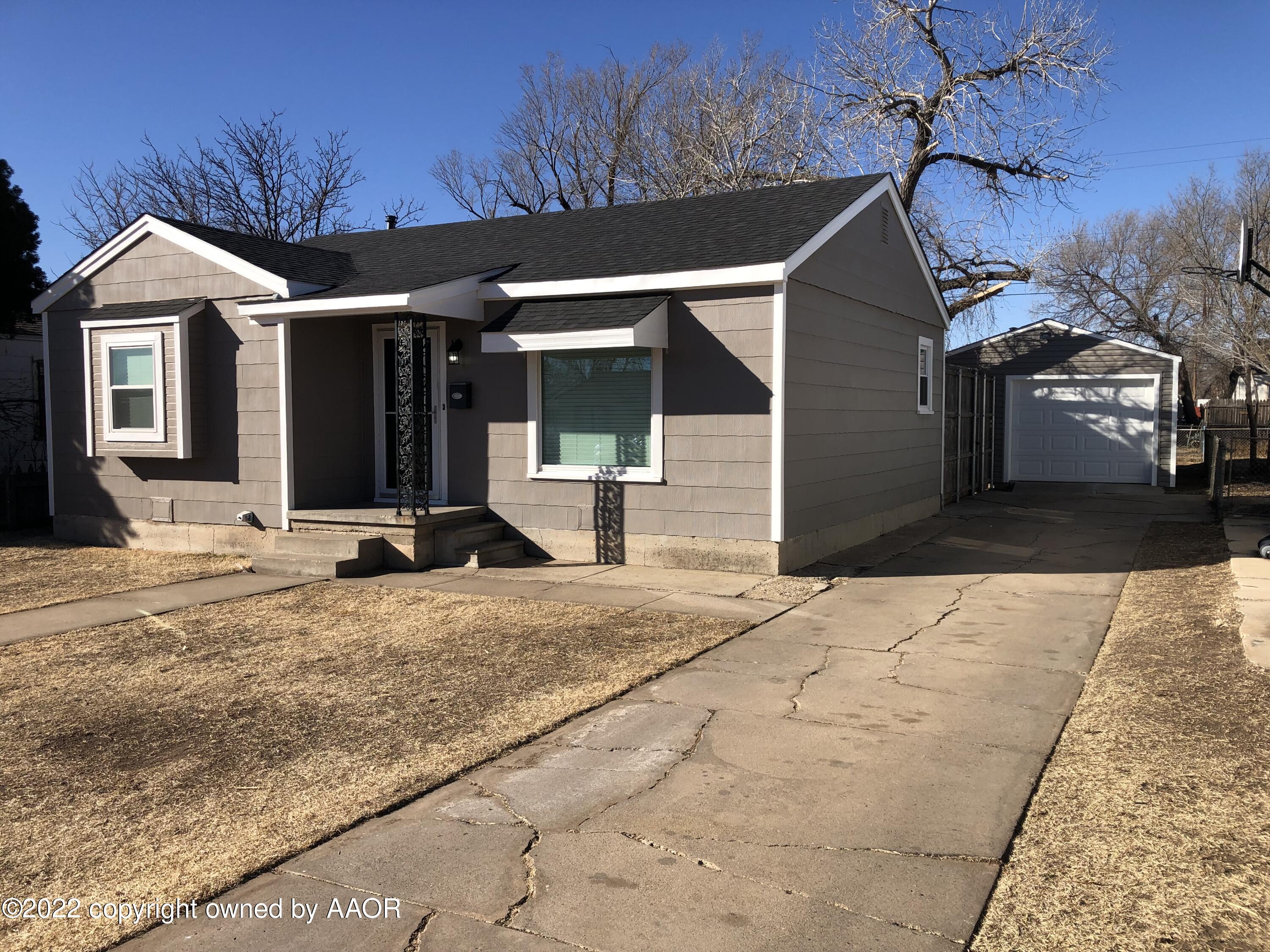 4122 Gables Street Amarillo, TX 79110 - Photo 2 of 2 a front view of a house with a yard and garage