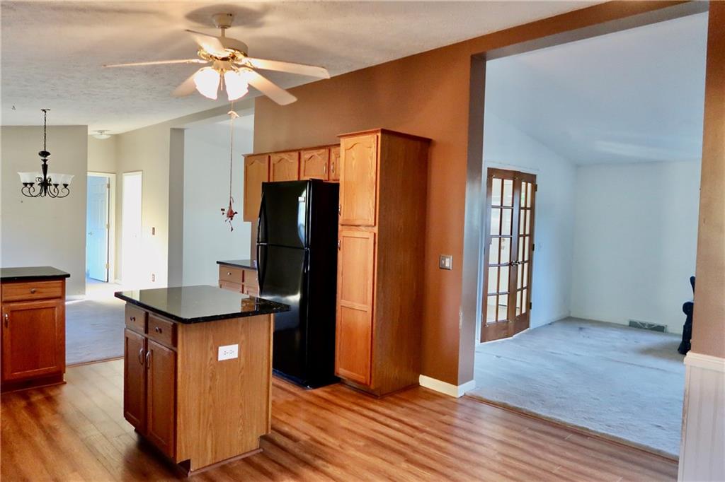 128 Airport Road Mercer, PA 16137 - Photo 13 of 36 a kitchen with stainless steel appliances granite countertop a refrigerator a sink and a stove