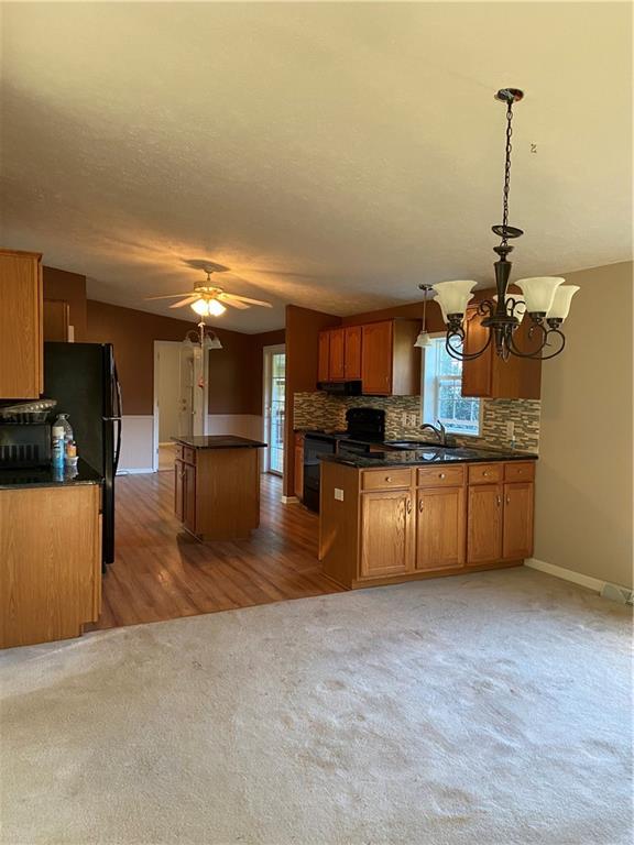 128 Airport Road Mercer, PA 16137 - Photo 14 of 36 a kitchen with stainless steel appliances kitchen island granite countertop a sink and cabinets
