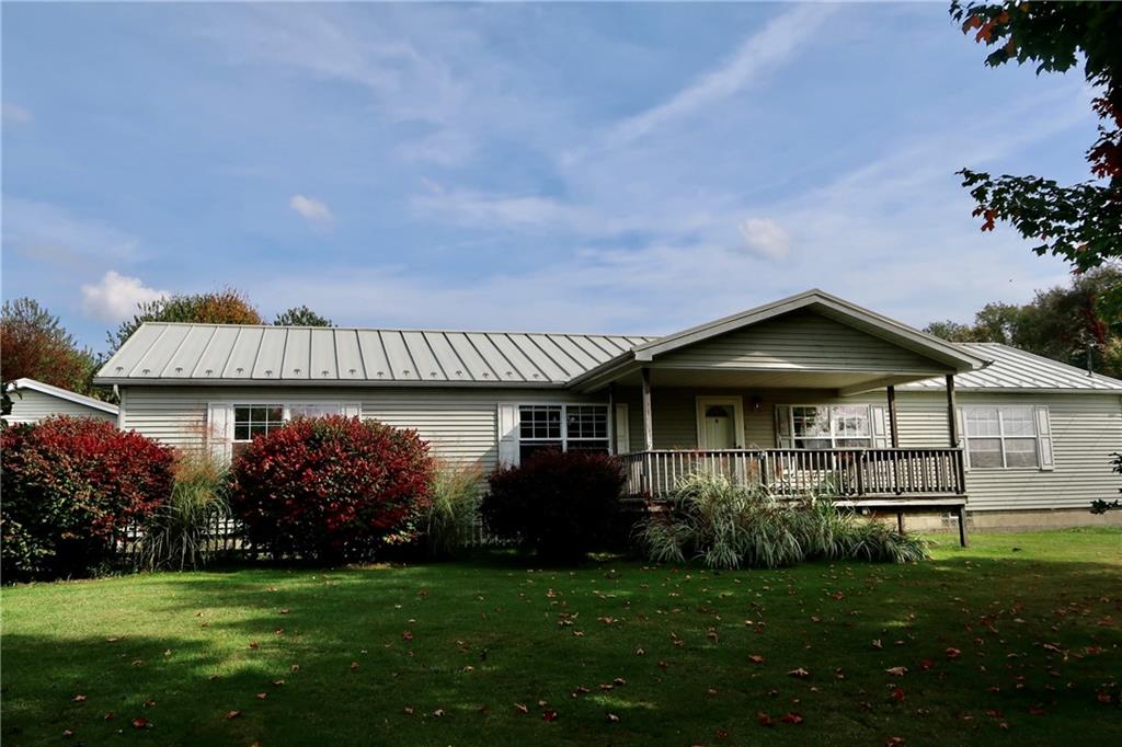 128 Airport Road Mercer, PA 16137 - Photo 2 of 36 a front view of a house with a garden