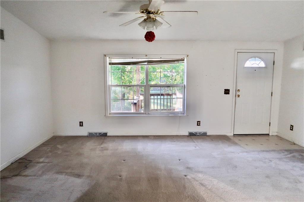 128 Airport Road Mercer, PA 16137 - Photo 25 of 36 an empty room with windows and fan