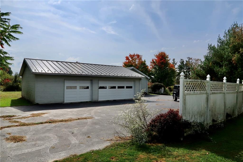 128 Airport Road Mercer, PA 16137 - Photo 32 of 36 a front view of a house with a garage