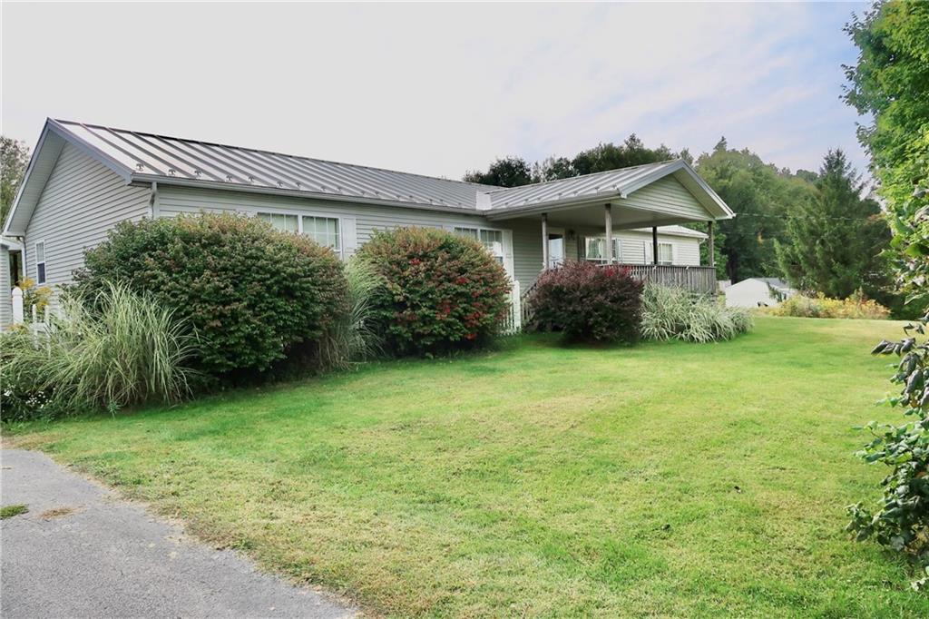 128 Airport Road Mercer, PA 16137 - Photo 7 of 36 a front view of a house with garden