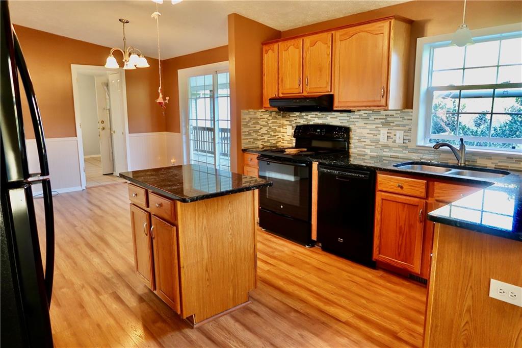 128 Airport Road Mercer, PA 16137 - Photo 8 of 36 a kitchen with stainless steel appliances granite countertop a stove a sink and a refrigerator