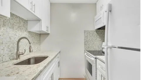 a kitchen with a sink and a refrigerator