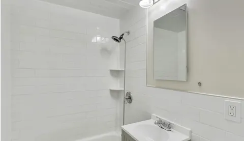 a bathroom with a sink and shower