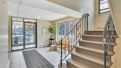 a view of staircase with white walls and windows