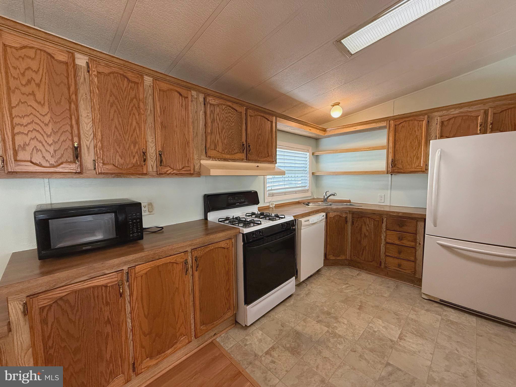 386 Indian Way Buena, NJ 08310 - Photo 6 of 53 a kitchen with stainless steel appliances granite countertop a stove a sink and a refrigerator
