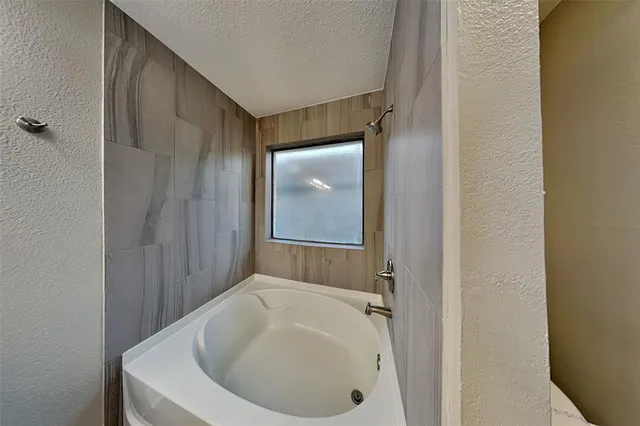 a bathroom with a tub and shower