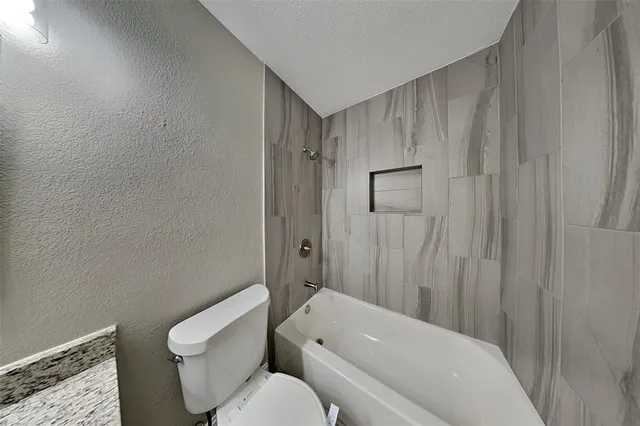a bathroom with a toilet a sink and bathtub