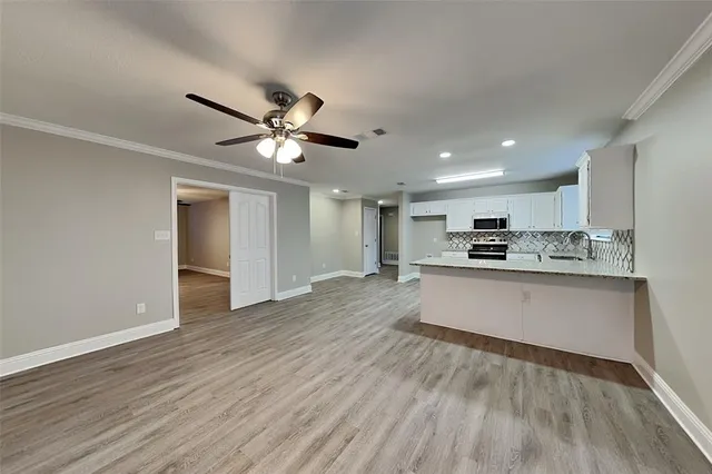 a view of kitchen with refrigerator microwave and stove