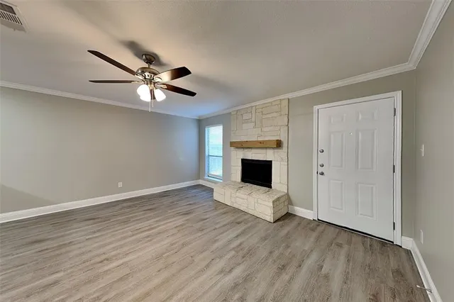 wooden floor in an empty room with a fireplace