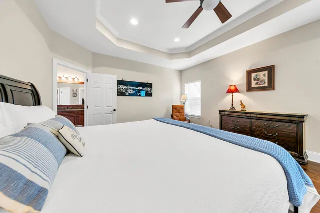 a bedroom with bed and wooden floor