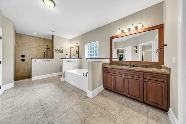 a large bathroom with a large tub and sink