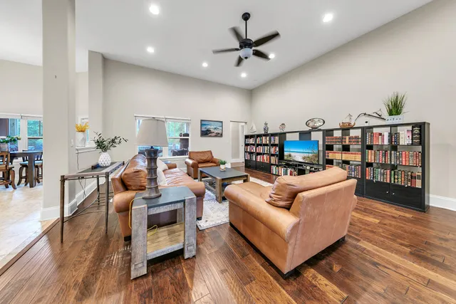 a living room with furniture and a wooden floor