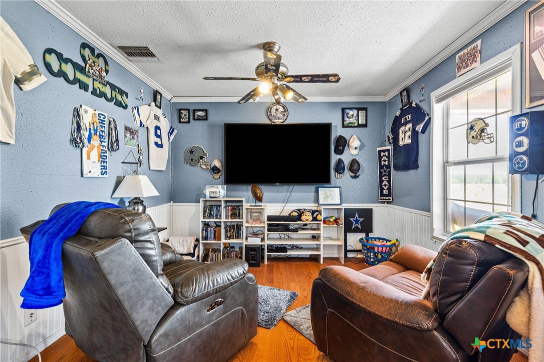 425 Old Pleasanton Road Poteet, TX 78065 - Photo 12 of 38 a living room with furniture a flat screen tv and a chandelier