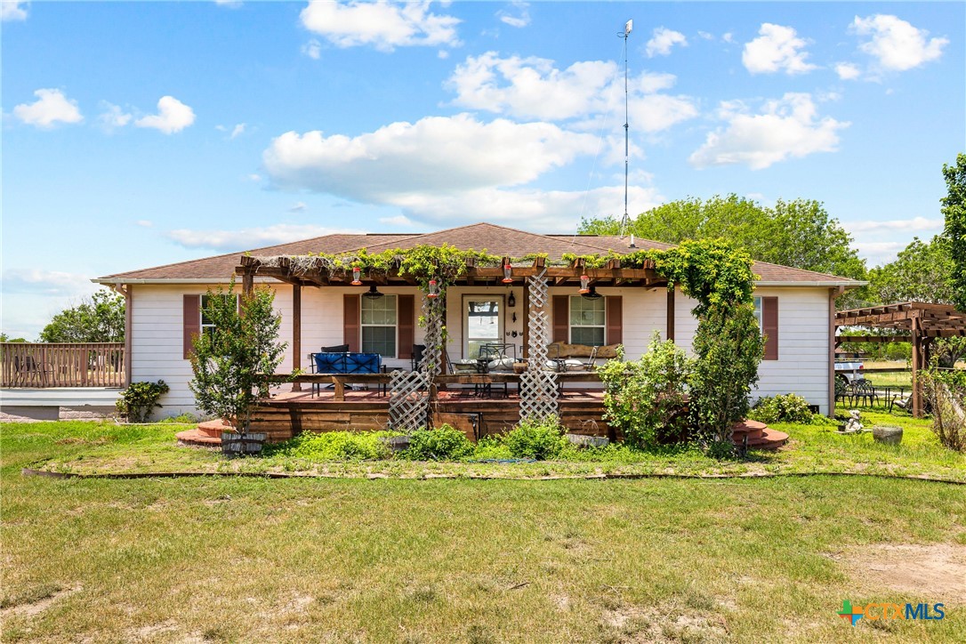 425 Old Pleasanton Road Poteet, TX 78065 - Photo 2 of 38 a view of a house with a big yard potted plants and large tree