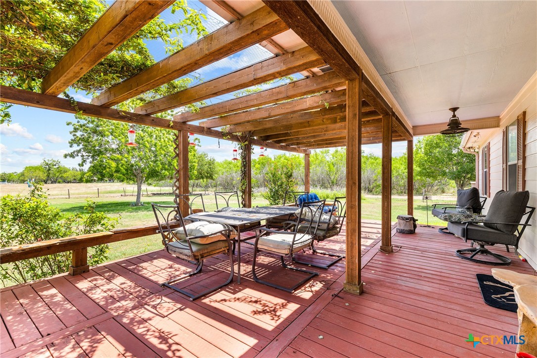 425 Old Pleasanton Road Poteet, TX 78065 - Photo 6 of 38 a living room with patio furniture and a floor to ceiling window