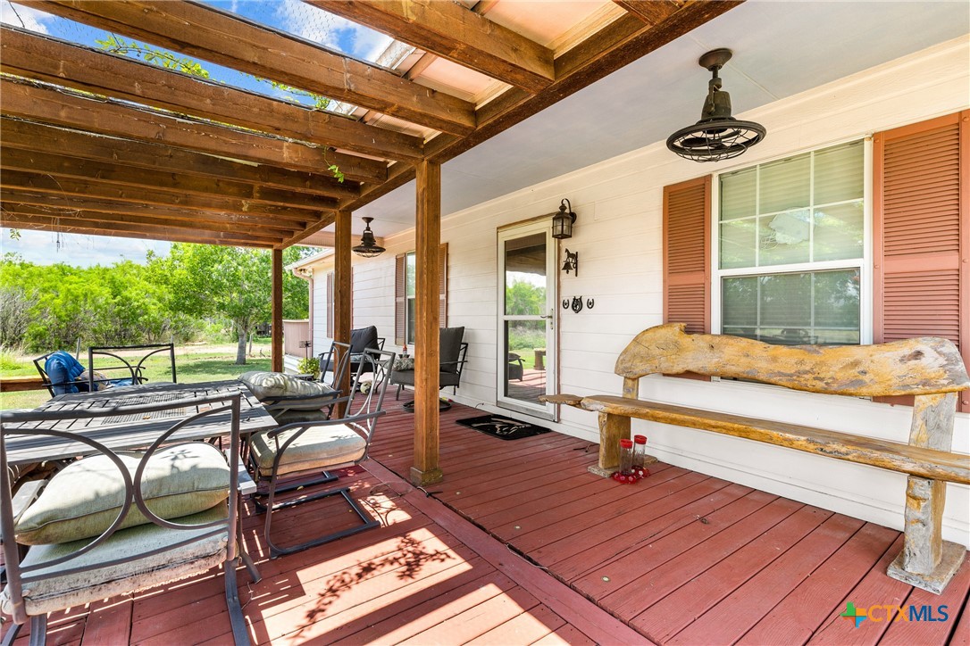 425 Old Pleasanton Road Poteet, TX 78065 - Photo 7 of 38 a living room with patio furniture and a large window