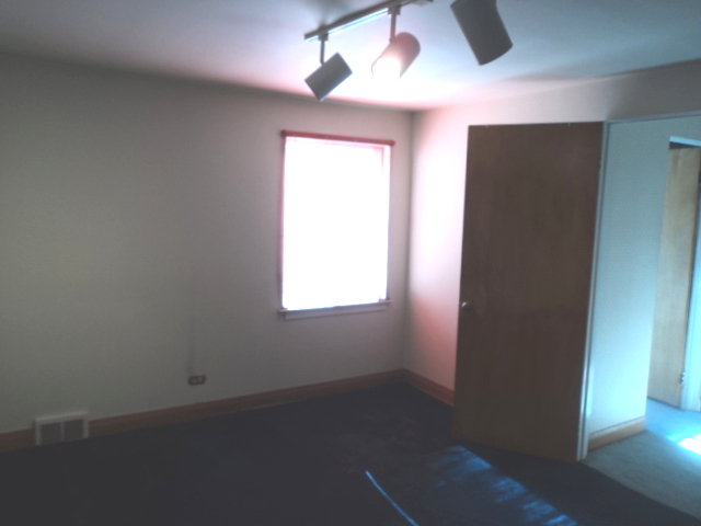 161 Gage Road Riverside, IL 60546 - Photo 20 of 32 an empty room with a window and a fan