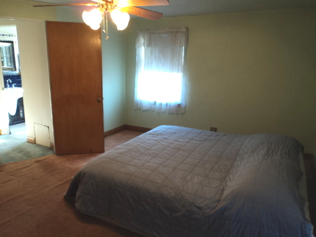 161 Gage Road Riverside, IL 60546 - Photo 25 of 32 a bedroom with a bed and a chandelier