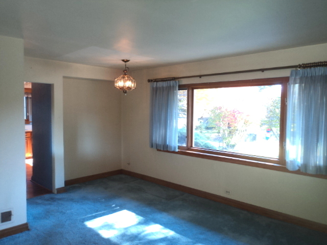 161 Gage Road Riverside, IL 60546 - Photo 10 of 32 an empty room with wooden floor and windows
