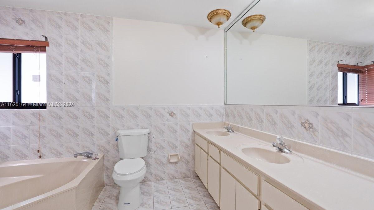 1140 Southwest 85th Court Miami, FL 33144 - Photo 11 of 13 a bathroom with a sink a toilet and shower
