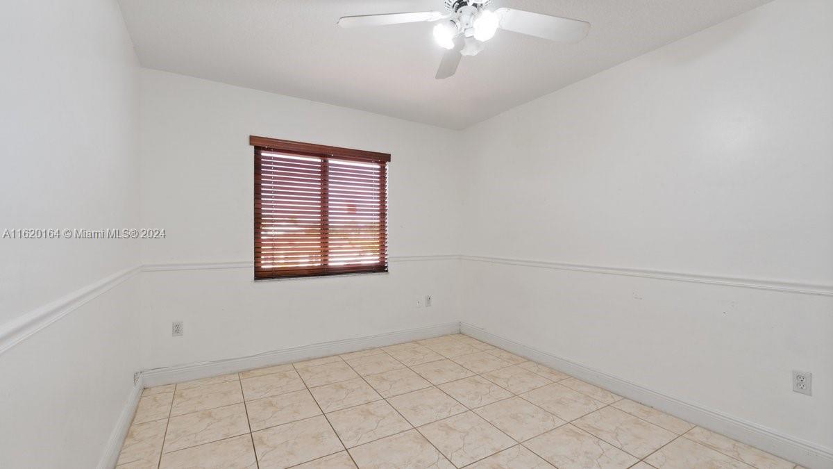 1140 Southwest 85th Court Miami, FL 33144 - Photo 12 of 13 an empty room with a empty space and windows