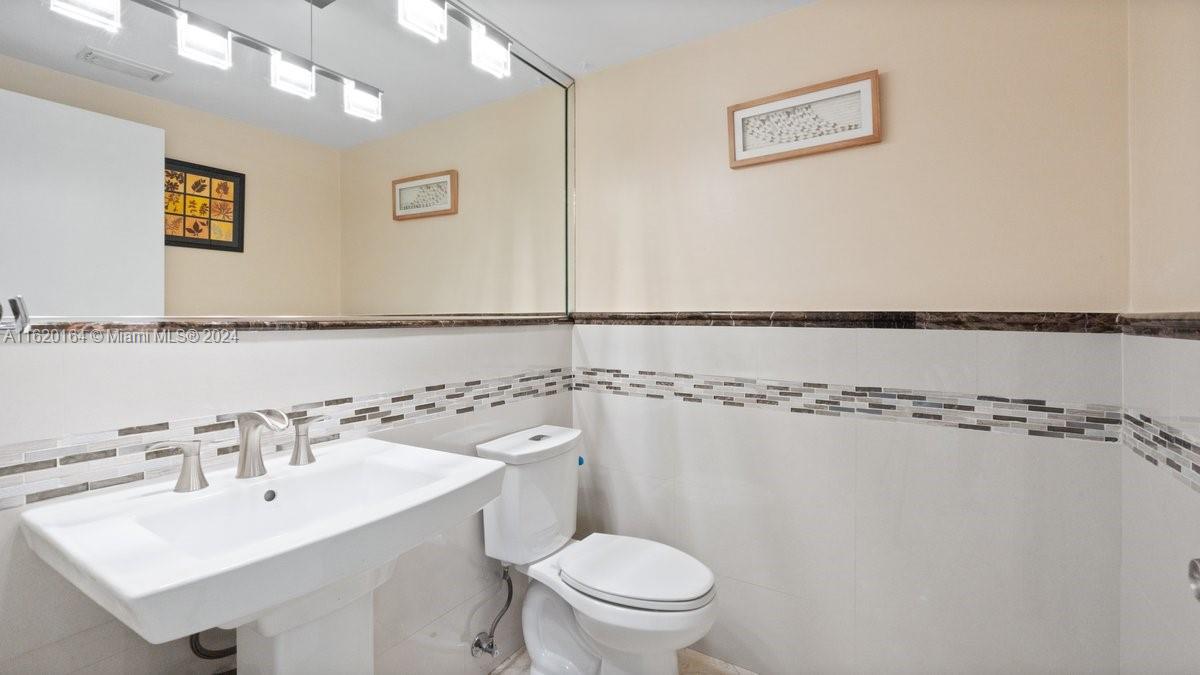 1140 Southwest 85th Court Miami, FL 33144 - Photo 4 of 13 a bathroom with a sink mirror toilet and shower