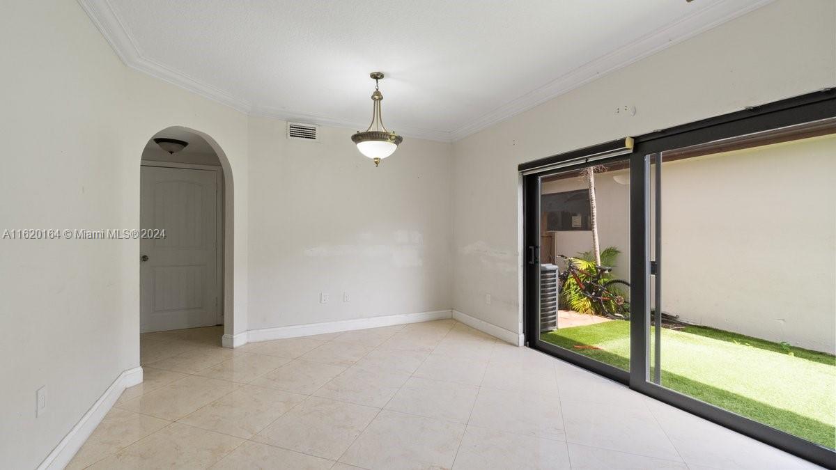 1140 Southwest 85th Court Miami, FL 33144 - Photo 6 of 13 an empty room with window