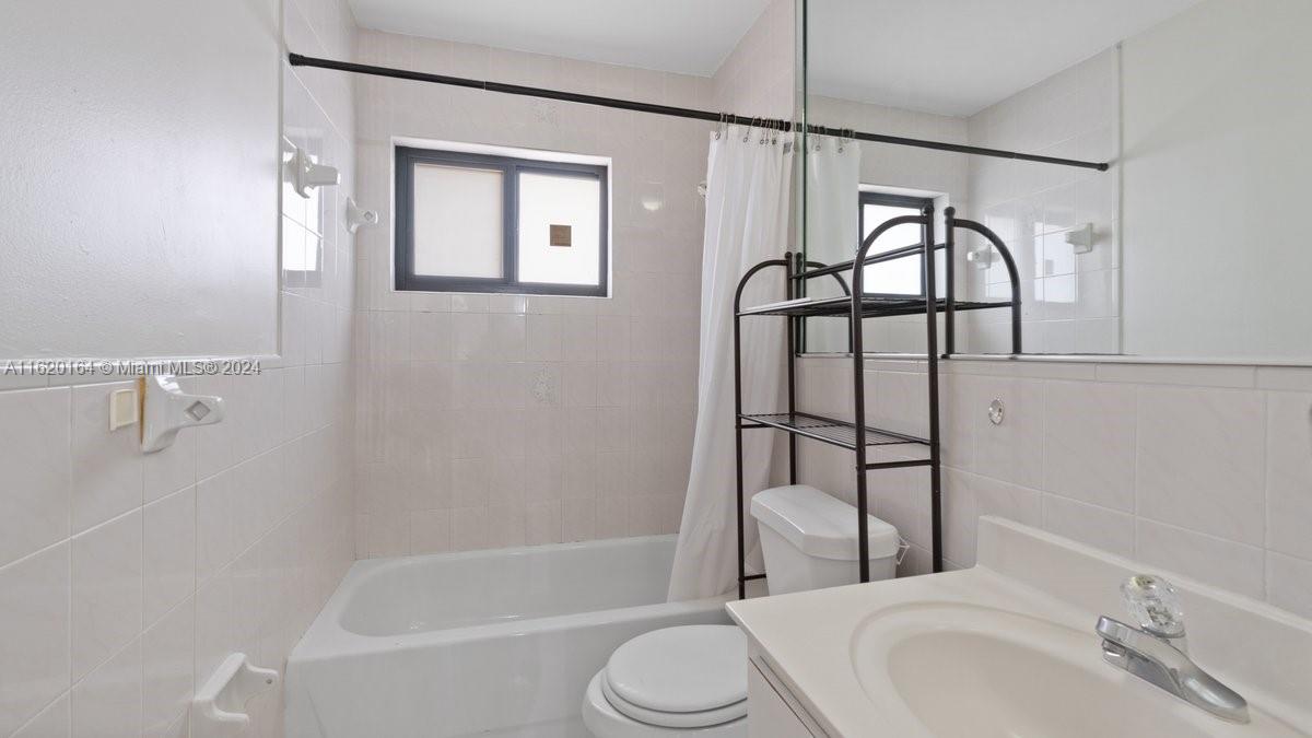 1140 Southwest 85th Court Miami, FL 33144 - Photo 9 of 13 a bathroom with a sink toilet and shower