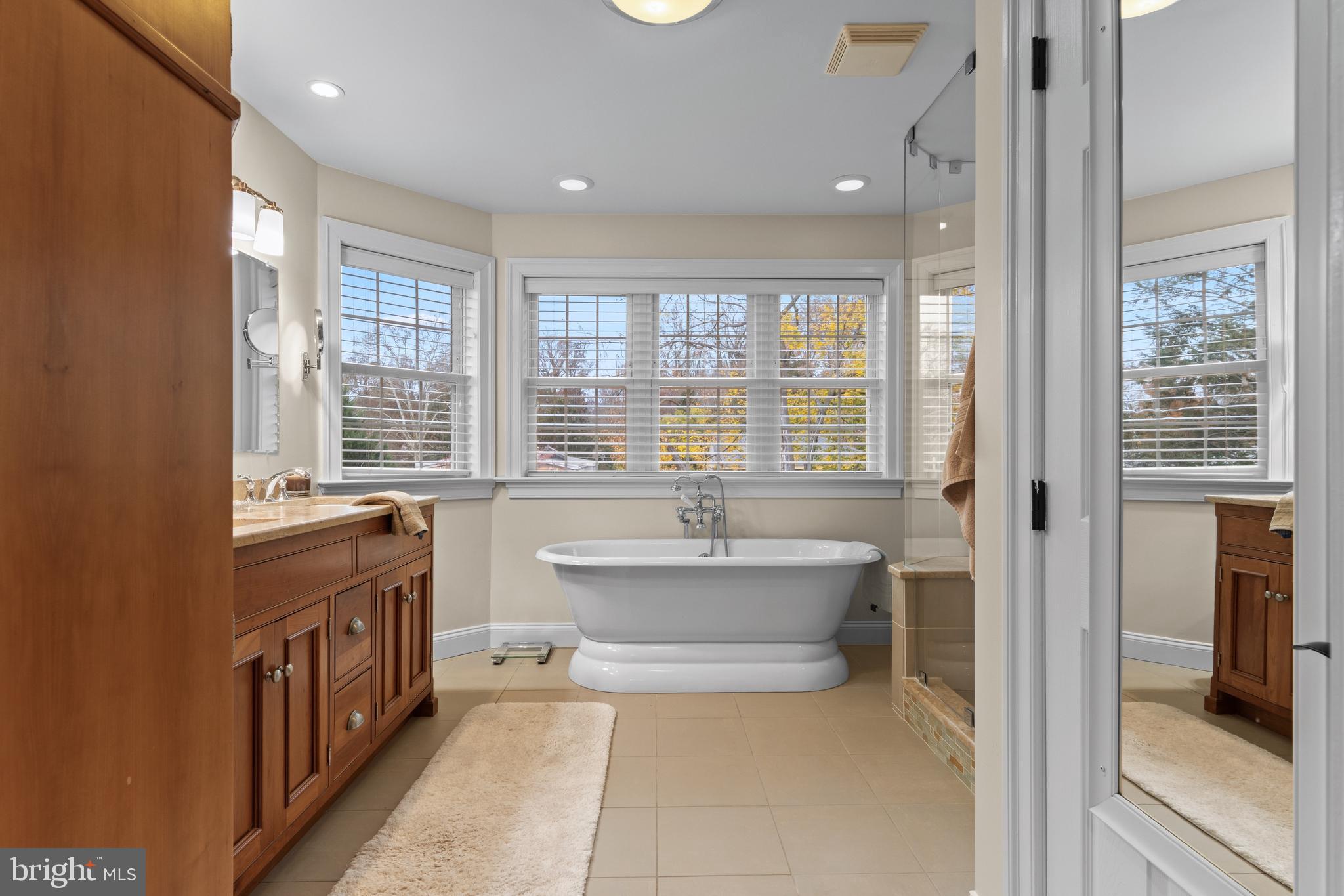 330 Dudley Avenue Narberth, PA 19072 - Photo 11 of 21 a bathroom with a bathtub a sink a mirror and a bathtub