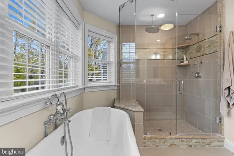 a bathroom with a bathtub and a shower